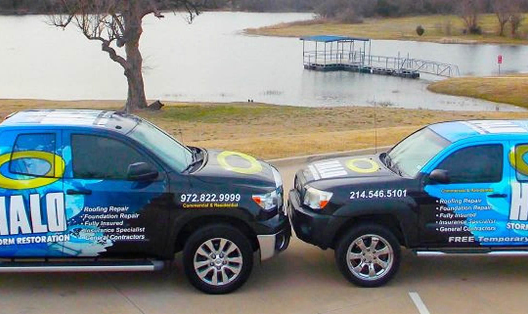 Two blue service trucks showing company wrap